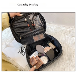 Internal view of black quilted makeup bag showing brush slots and mesh pocket storage