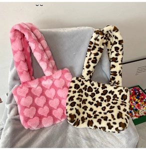 Detail view of plush tote bags in pink heart texture and beige leopard print faux fur