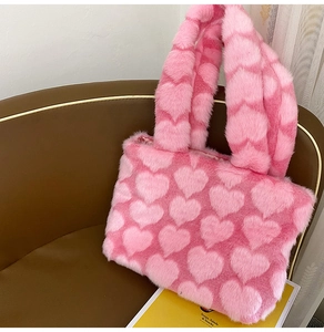 Detailed view of the soft pink plush tote bag with lovely heart patterns for women