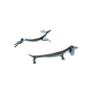 Polished metal animal shaped chopstick holders featuring deer and dachshund designs