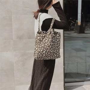 Detail of leopard print canvas tote bag showing texture and double shoulder straps