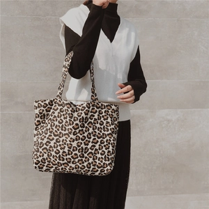 Close-up of leopard print canvas tote bag with wide straps and spacious interior