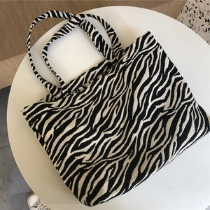 Detail shot of the textured zebra pattern knitting on a black and white canvas tote bag