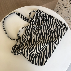 Detailed view of the black and white zebra pattern canvas tote bag with a soft fabric handle