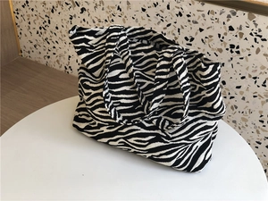 Macro detail of zebra print canvas tote bag fabric with textured woven surface