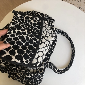 Close-up of black and white leopard pattern jacquard canvas tote bag with flap opening