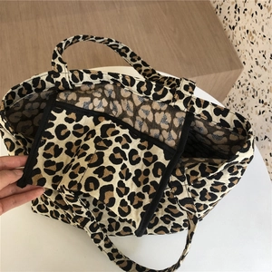 Detail view of leopard print tote bag interior showing the practical inner pocket and lining