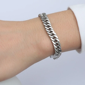 Close-up of silver Cuban link bracelet worn on male wrist with durable metal finish
