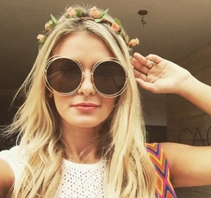 Close-up of retro double-rim metal sunglasses with oversized round tinted lenses on model