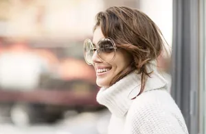 Close-up of oversize round metal sunglasses with double-rim design on a female model