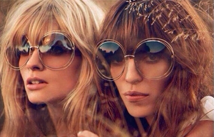 Close-up of vintage round metal oversized sunglasses with gradient ocean lenses