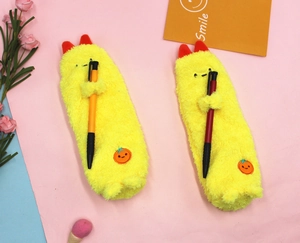 Detailed view of yellow plush monster pencil case with soft texture and storage capacity