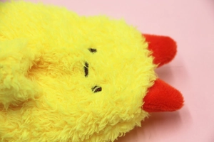Close-up of cute yellow plush pencil case featuring red corner character details