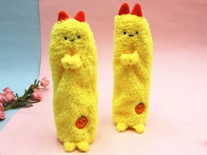 Detail of yellow plush pencil case with soft faux fur texture and cute red top accent