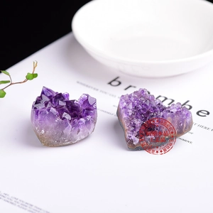Close-up of heart-shaped natural amethyst cluster showing raw crystal texture and purple hues