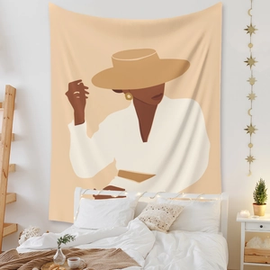 Detail of bohemian tapestry featuring a minimalist abstract woman on a bedroom wall