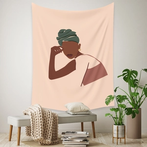 Detail view of Bohemian tapestry featuring an abstract portrait in a warm home setting