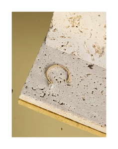 Detail of S925 silver gold-plated ring with white pearl and zircon on stone background