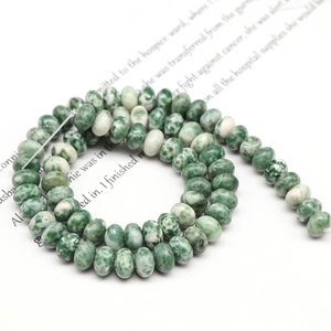 Macro view of green and white marble pattern abacus beads for DIY jewelry making