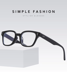 Detailed macro view of black square frames with classic metal rivets on smooth temples