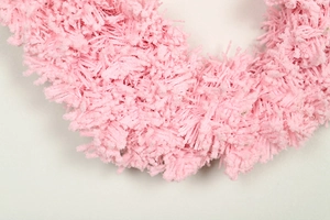 Close-up of pink flocked fibers and fluffy texture for DIY Christmas wreath decoration