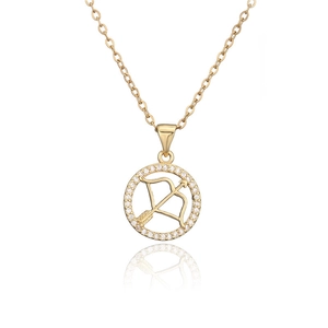 Macro detail of gold Sagittarius zodiac pendant necklace with micro-pave crystals