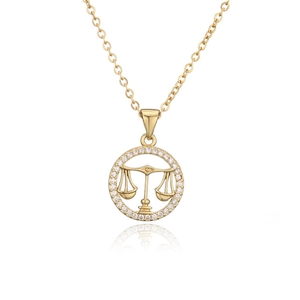 Detail of gold Libra zodiac pendant with micro-paved crystals on a delicate O-chain
