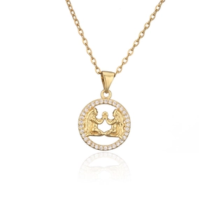 Macro shot of gold Gemini zodiac pendant with micro-set zircon stones and O-chain