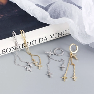 Detailed shot of S925 silver cross tassel earrings in gold and silver finishes