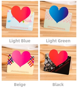 Set of 3D heart greeting cards in four artistic colors on a rustic wooden tray display