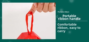 Detail of red Christmas gift box featuring portable silk ribbon handle and snowflake patterns