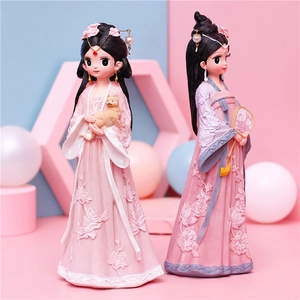 Close-up of Hanfu girl figurines with floral embroidery and cat detail in pastel colors