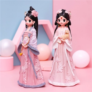 Close-up of Hanfu girl figurines with floral relief texture and golden cat detail