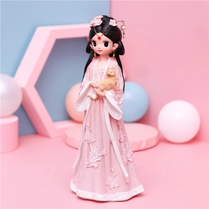 Close-up of a cute girl figurine in pink Hanfu holding a small cat for home decor