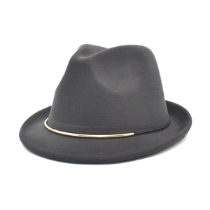 Close-up of dark grey wool felt fedora featuring a thin black band and gold metal trim