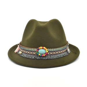 Detail of olive green felt fedora featuring bohemian beaded band and turquoise stone