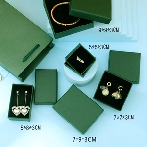 Detail showing various sizes of dark green jewelry gift boxes with dimension labels