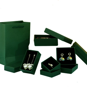 Dark green jewelry gift box set including paper bag and various cases for rings or necklaces