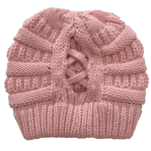 Detail of pink knitted winter hat featuring a unique cross-stitch pattern and ribbed edge