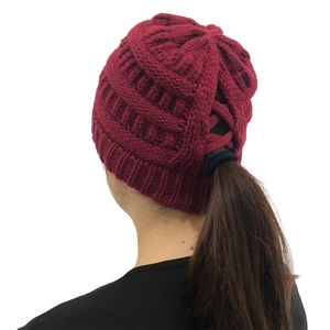 Detail of burgundy knit ponytail beanie showing the cross-over opening for hair