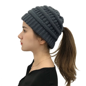 Detail showing high-quality chunky knit texture and ponytail hole design on warm winter hat