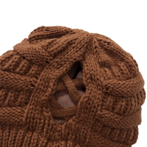 Brown knit beanie with ponytail hole and cross knit texture for autumn and winter
