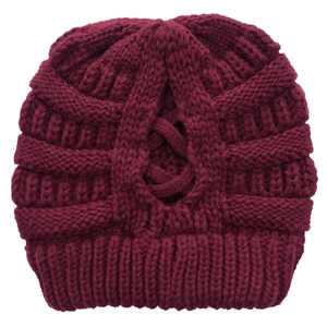 Close-up of burgundy knit beanie showing thick wool texture and cross-knit design