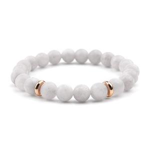 Macro view of white natural stone bead bracelet with rose gold metal spacers