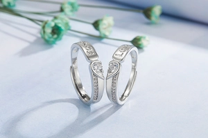 Detail of silver couple rings with heart-shaped zircon and Forever Love engraving