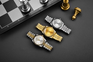Luxury quartz watches with metal bands, calendar display and classic fluted bezel details