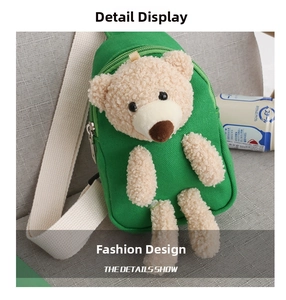 Detail view of green canvas children's chest bag featuring a plush 3D teddy bear doll