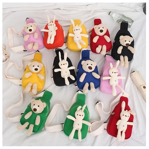Close-up of cute cartoon canvas chest bags with plush bear and bunny 3D decorations