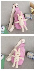 Detail of pink canvas crossbody bag for kids featuring a cute plush bunny and zipper