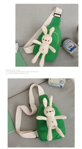 Detail of green canvas kids chest bag featuring a cute plush bunny and adjustable strap